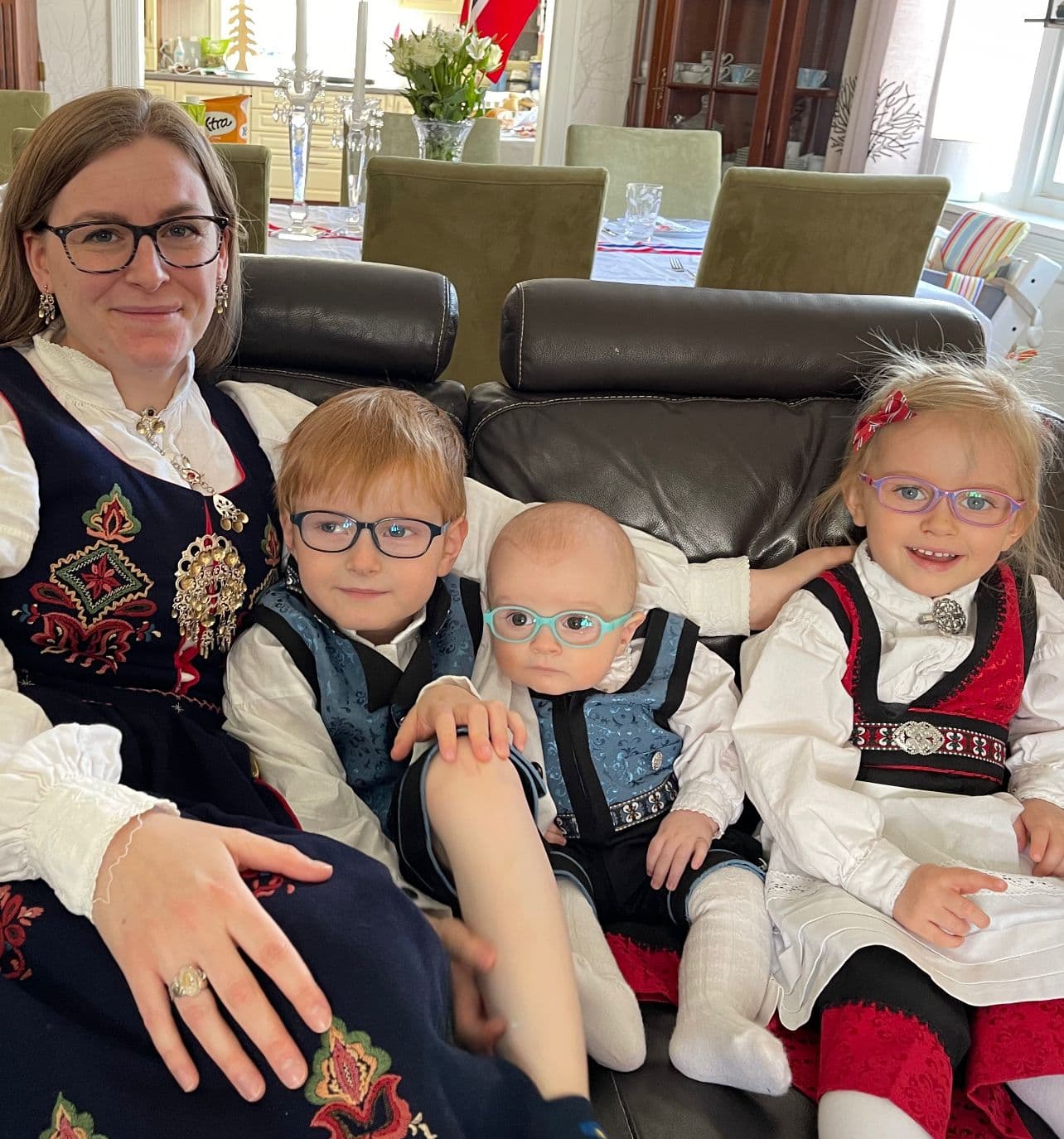 Mamma Henriette med Ulrik, Sigmund og Klara. Alle fire har på seg flotte bunader.